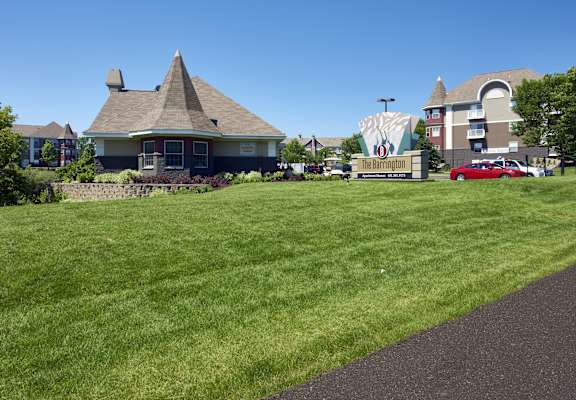a large lawn in front of a house with a sign for a movie theater