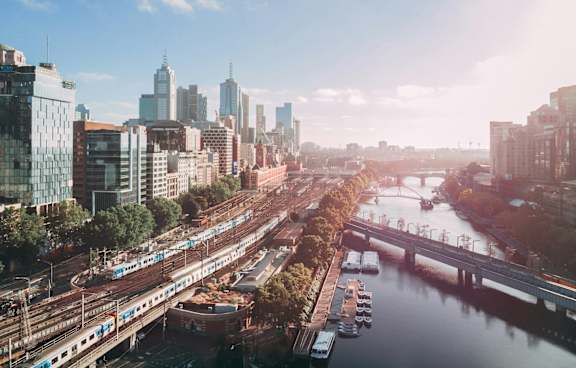 a living room with a green couch and a balcony