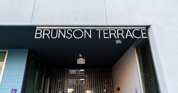 The entrance to a building with the name Brunson Terrace on it.