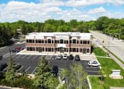 Thumbnail 1 of 8 - an aerial view of a building with cars in a parking lot