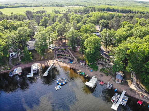 an aerial view of a lake with boats and a dock