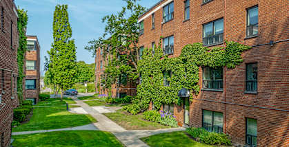 A red brick building with green plants growing on it at Queen St East in Scarborough, ON