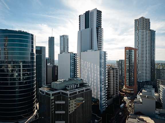 A cityscape with tall buildings and a clear sky.