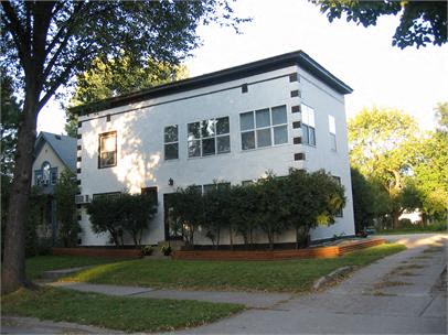 a white house with trees in front of it