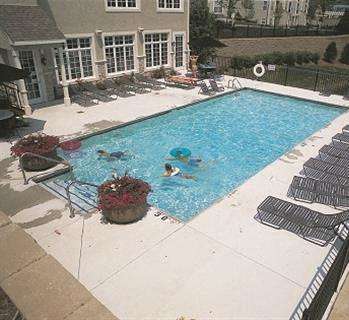 a couple of people are swimming in a pool at The Sanctuary of Lake Villa, Lake Villa, IL
