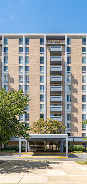 a balcony with a view of the city and trees at Waterford Tower Silver Spring, LLC, Silver Spring
