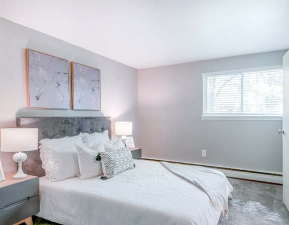 a bedroom with a bed and two night stands