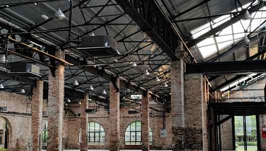 A large open space with brick pillars and a glass roof.
