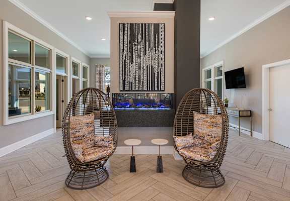 two chairs in front of a fireplace in a lobby