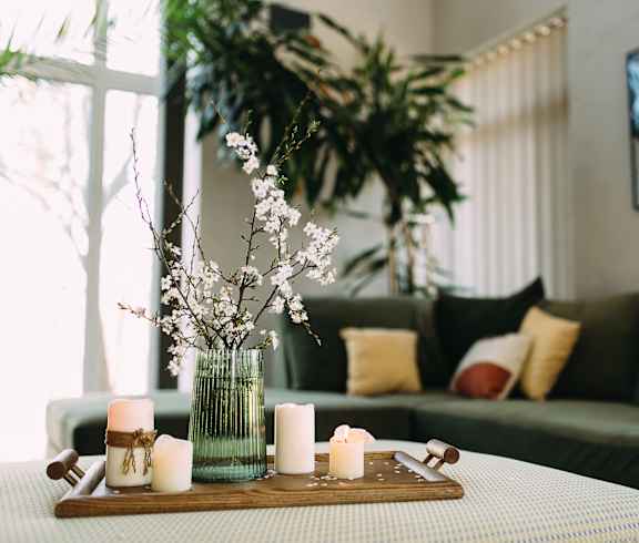 A table with candles and a vase of flowers.