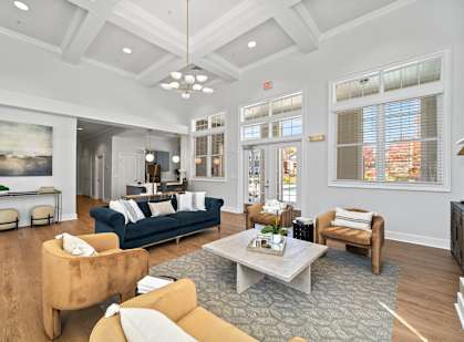 A living room with a blue couch and a brown armchair.