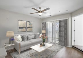 a living room with a couch and a ceiling fan