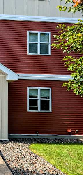 A red building with a black door and windows.