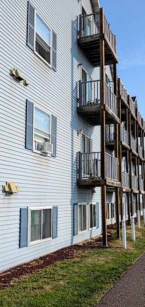 a building with balconies and a street in front of it