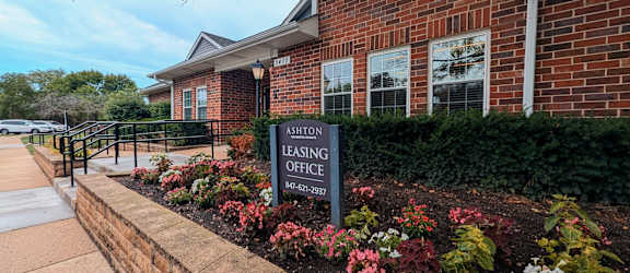 A brick building with a sign that says "Ashton Leasing Office".
