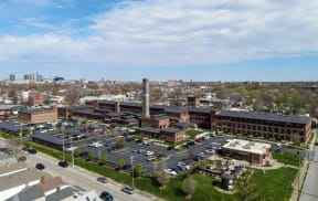 an aerial view of a city with a parking lot and buildings