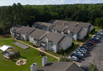 an aerial view of a row of houses with cars parked in front of them