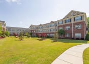 Thumbnail 26 of 30 - Community Courtyard with Picnic Tables and Grills at The Heritage at Arlington Apartment Homes, Greenville, North Carolina