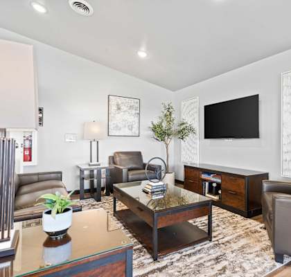 a living room with leather furniture and a television