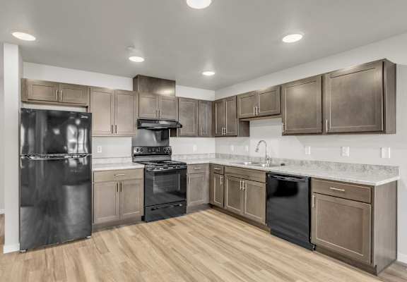 a kitchen with stainless steel appliances and wooden cabinets