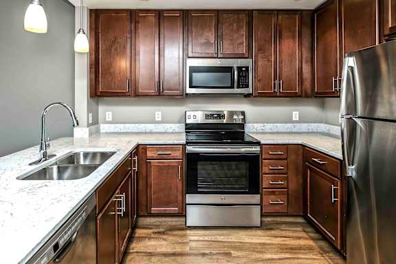 U-shaped kitchen with stainless steel appliances and white counters