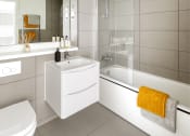 Thumbnail 12 of 12 - a white bathroom with a shower toilet and sink