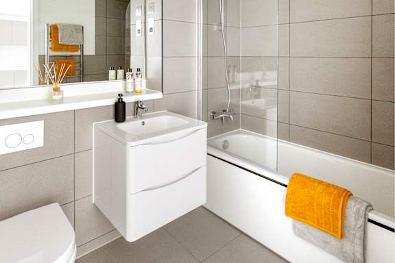 a white bathroom with a shower toilet and sink