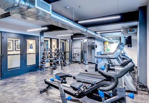 a gym with treadmills and other exercise equipment