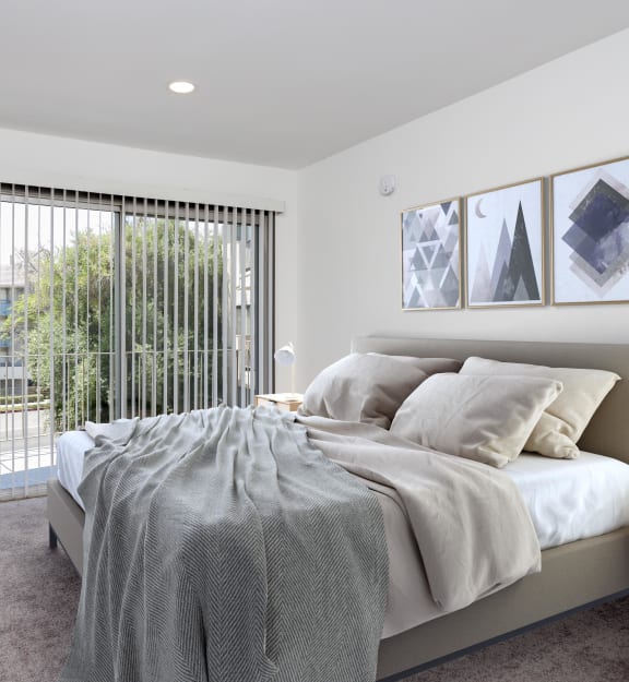 a bedroom with white walls and a carpeted floor