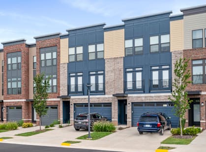 A row of townhouses with garages in front.