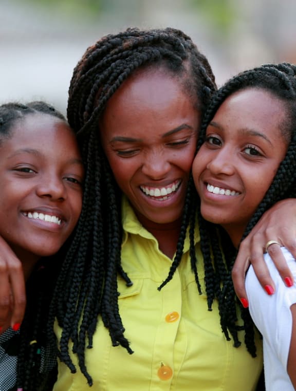 a group of girls hugging each other and smiling