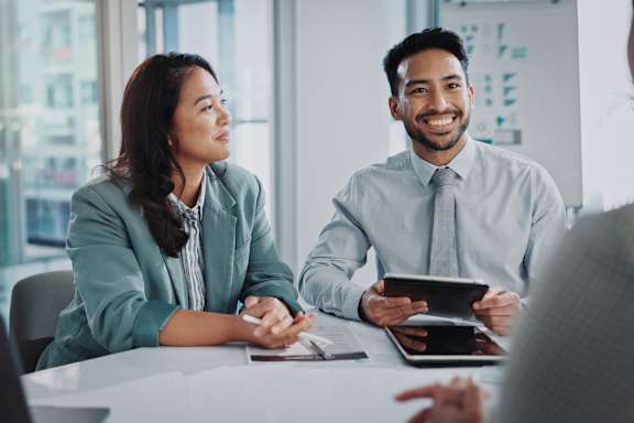 A man and a woman are having a meeting in a brightly lit room.