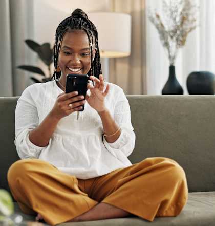 a woman sitting on a couch looking at her cell phone at The Langston Views, Washington, Washington