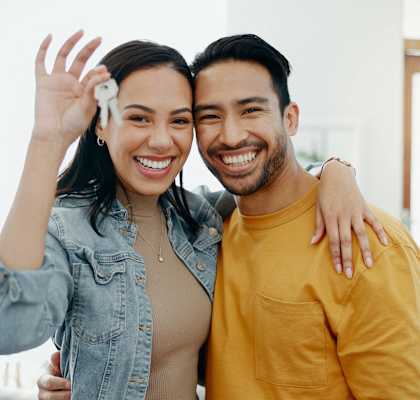 a man and woman posing for a picture in a room