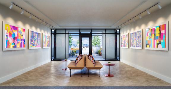A room with a couch, chairs and paintings on the wall.