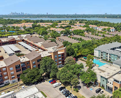 A bird's eye view of a residential area with a swimming pool and a bridge.