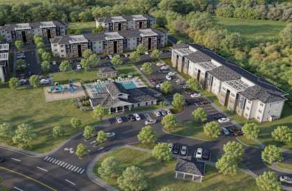 A large building complex with a parking lot in front.