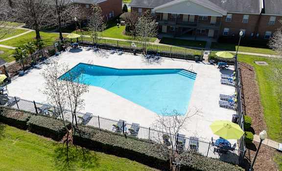 A large swimming pool surrounded by a black fence.