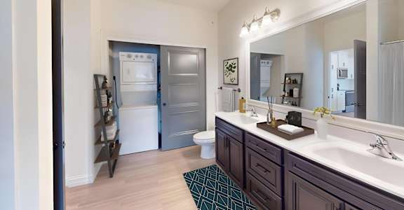 a bathroom with a large mirror and a sink and a toilet