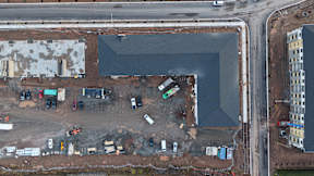 A construction site with a large hole in the ground.