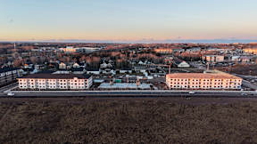 A large building complex sits in the middle of a town.