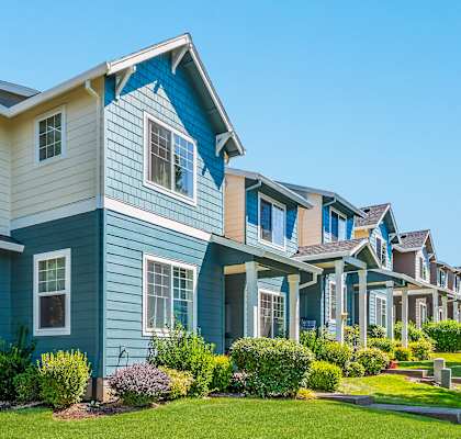 A row of townhomes with blue and white siding at The Landing Apartments and Townhomes, Oregon, 97045
