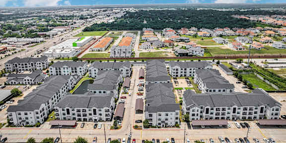 A large apartment complex with multiple buildings and parking lots.