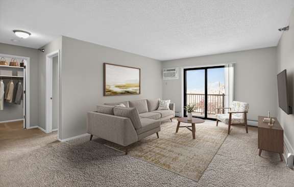 A living room with a grey couch, a brown rug, and a painting on the wall.