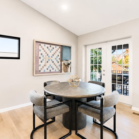 a dining room with a table and chairs