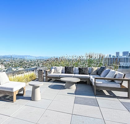 A rooftop patio with a view of the city.