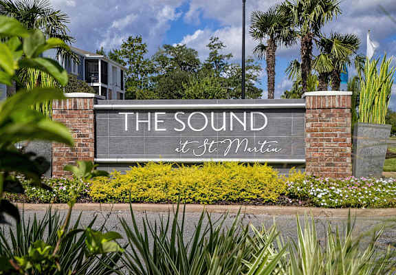 A sign that says "The Sound" is in front of a building.