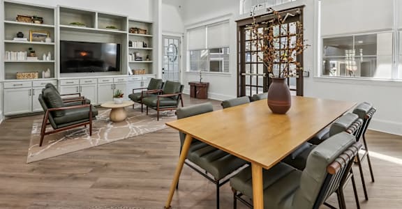 A dining room with a wooden table and chairs.