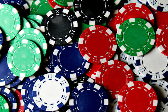a pile of different colored poker chips