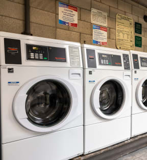 a row of washing machines in a laundromat